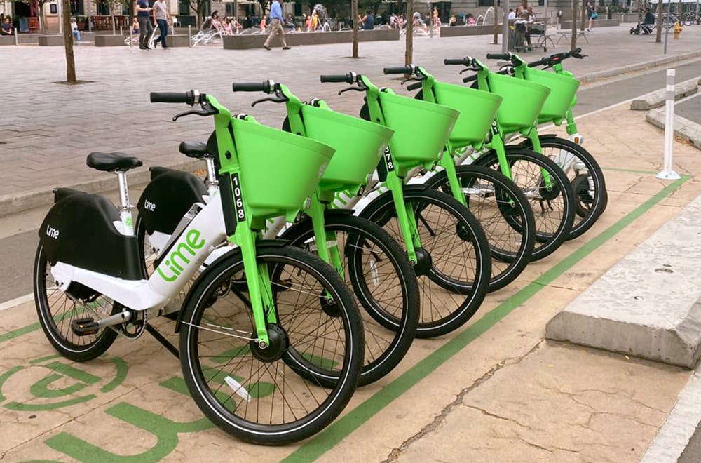 Lime bikes lined up in the bike parking area